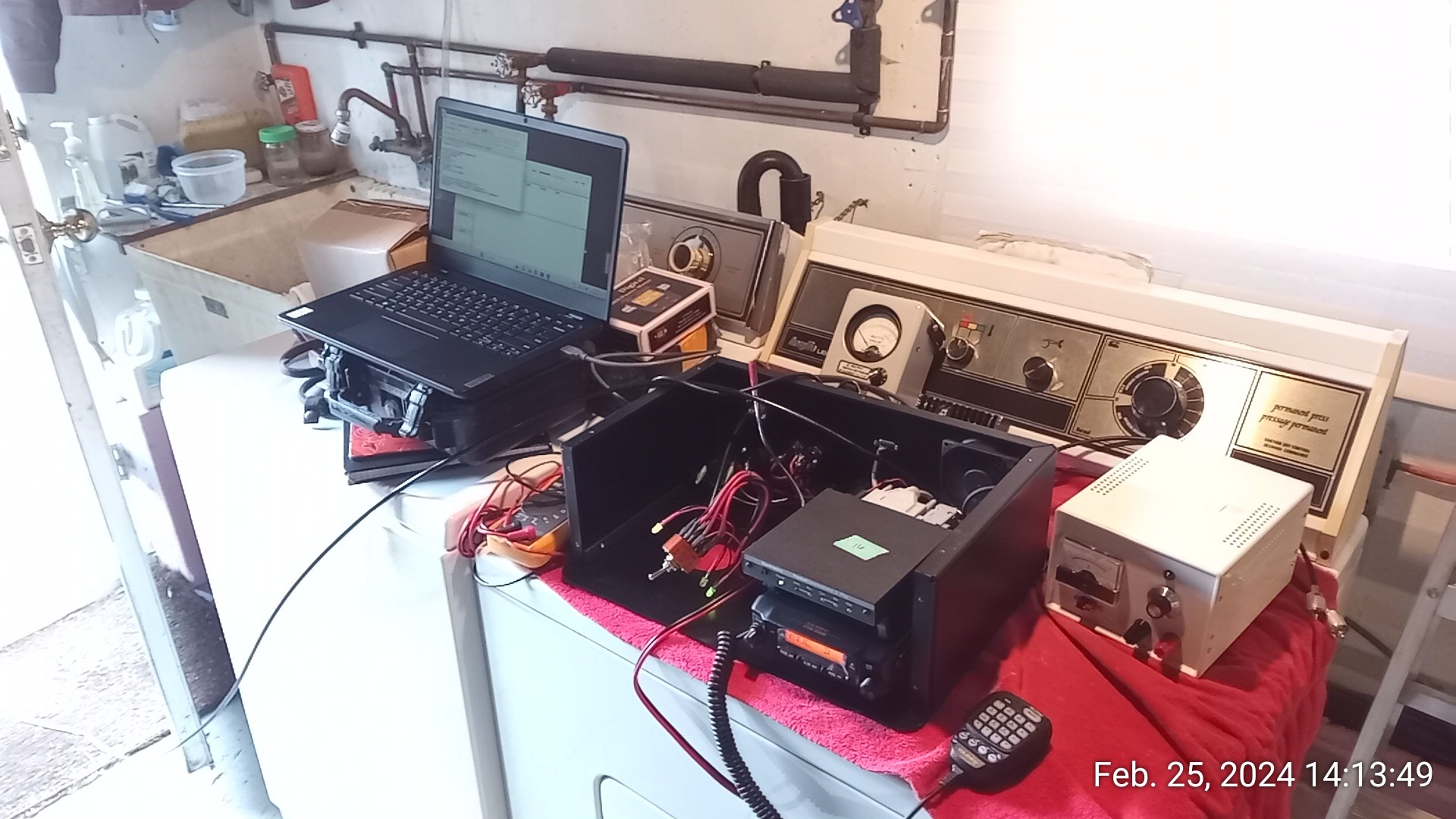 Testing setup - laptop, station, feedline meter with dummy load, and load generator